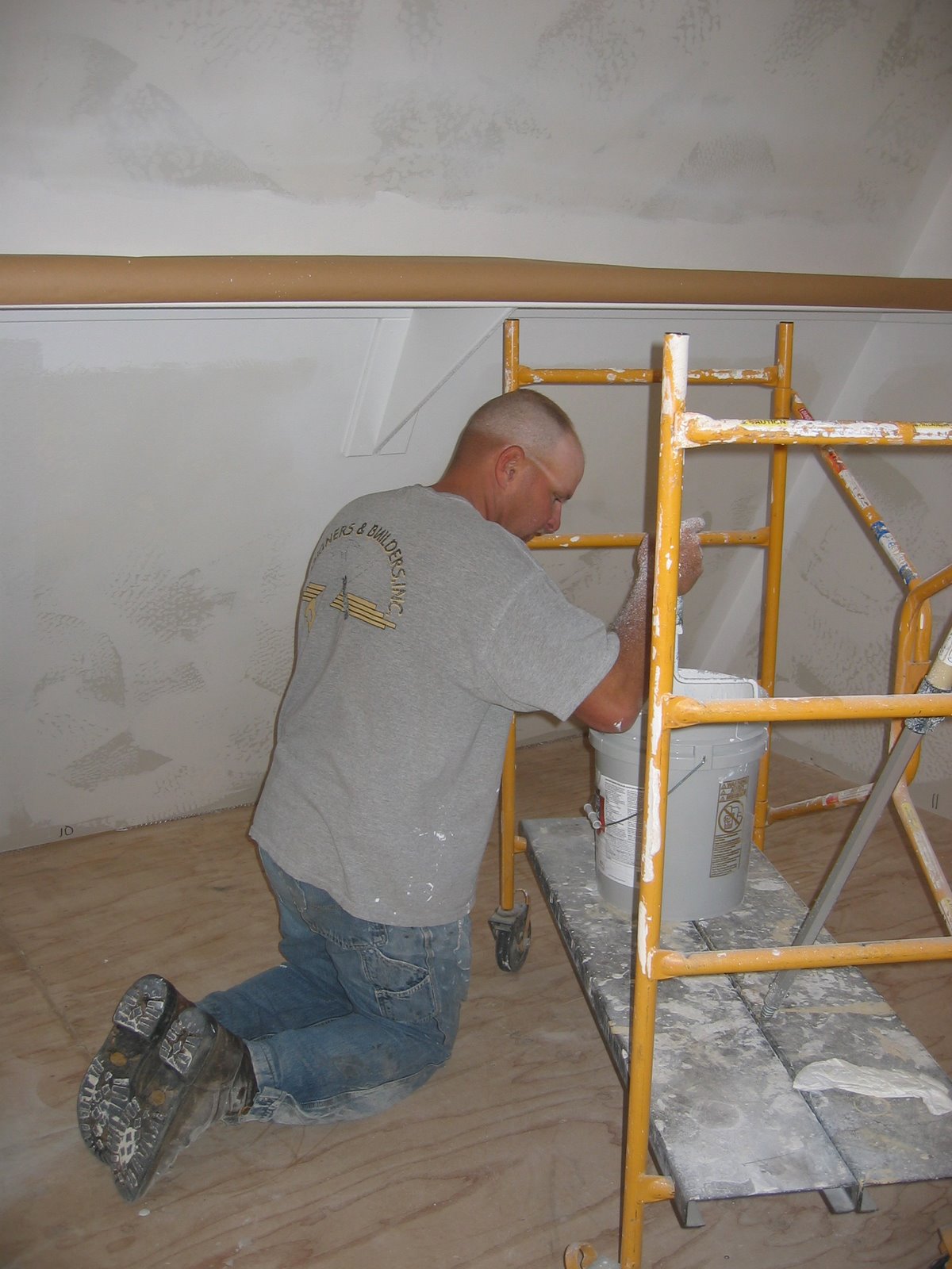 West is working on painting the second floor of the shop.