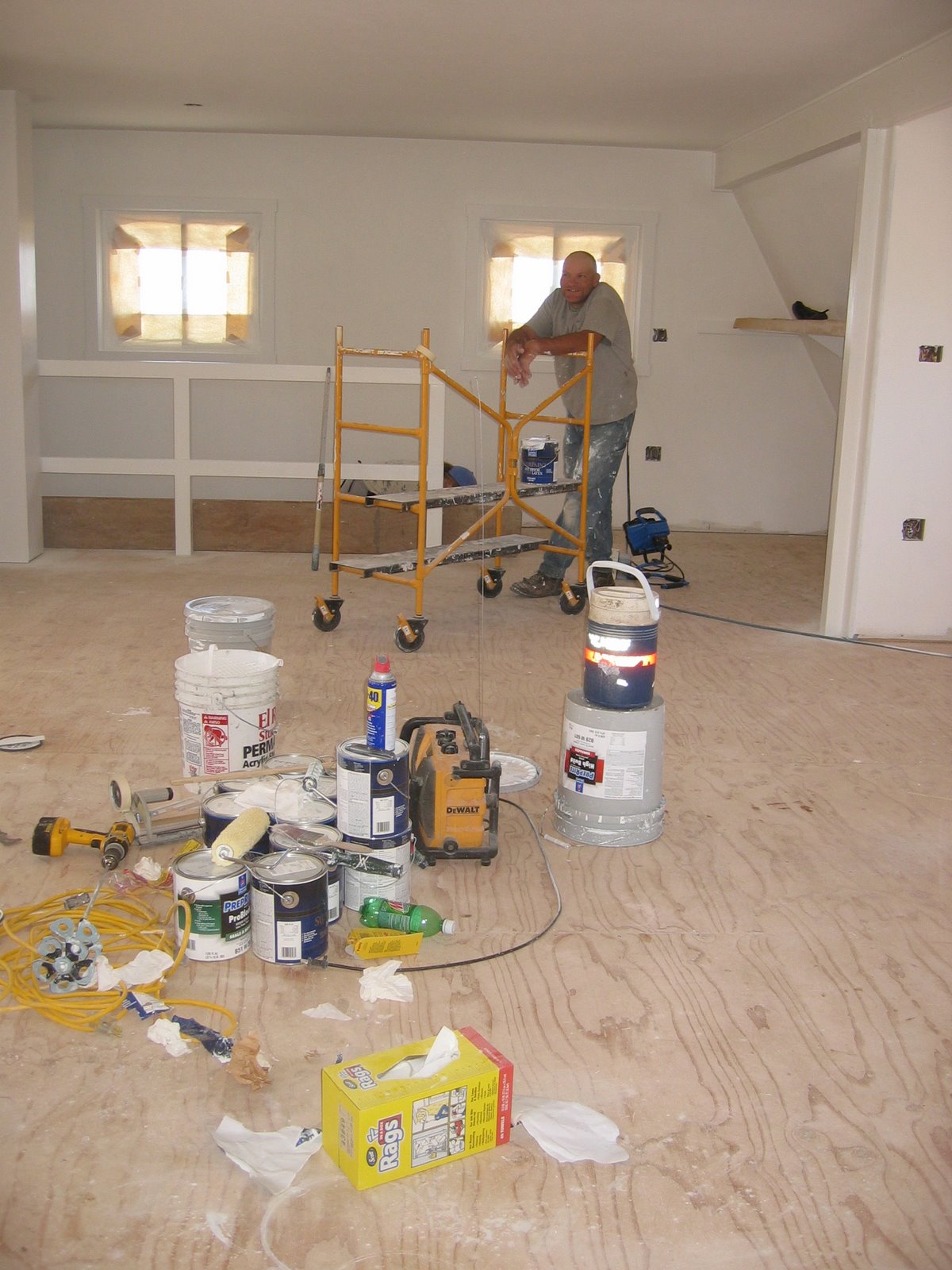 West is working on painting the second floor of the shop.