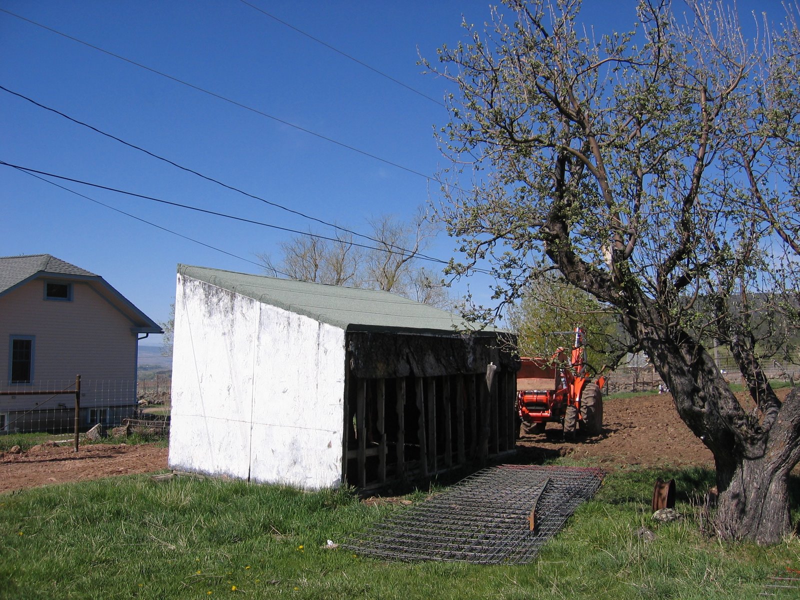 This old white shed is in the process of being demolished. 