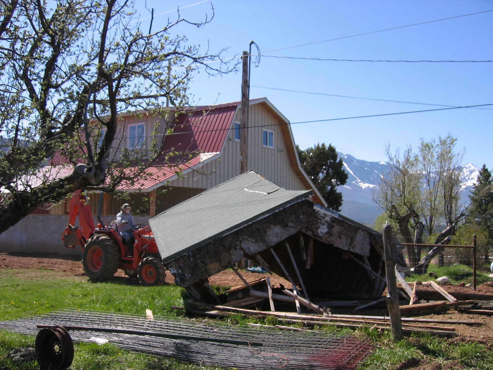 This old white shed is in the process of being demolished. 
