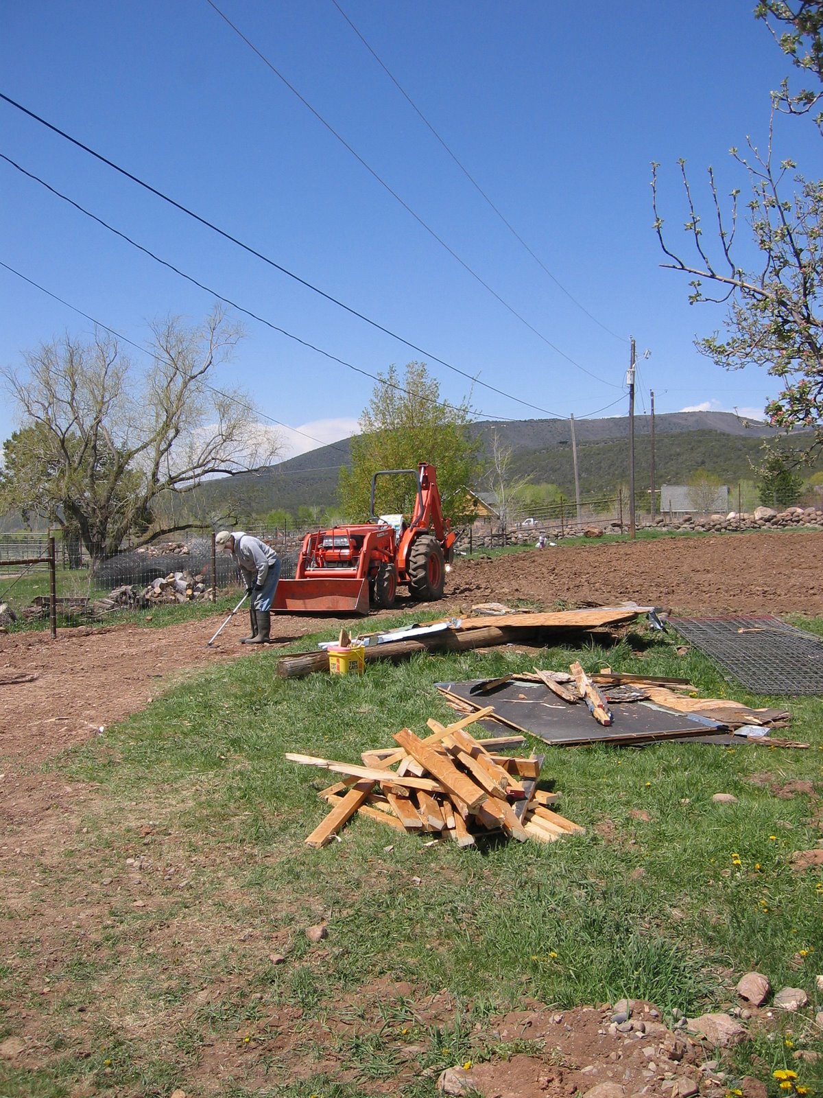 Ken picks up the remains of the white shed.