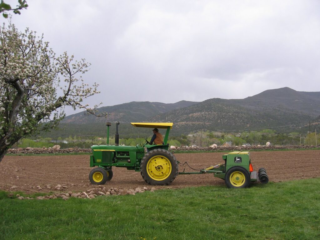 A John Deere tractor prepares to pull the seeder through this field.