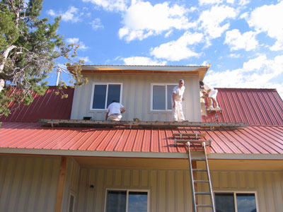 The painters are in the process of painting the body of the shop white. 