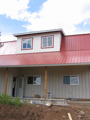 The shop has a white body with a red trim and roof. 