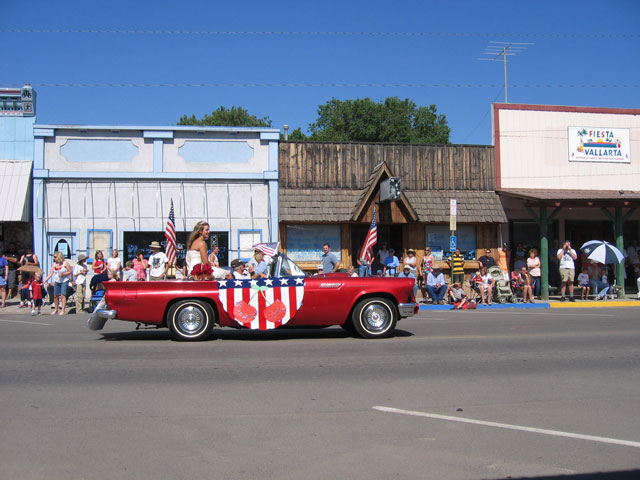 Another family with a classic car participates in the parade.