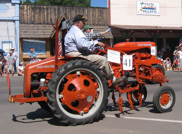 This restored tractor is making its way through the parade as well.