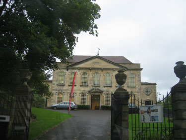 This manor house has an ornate gate in front. 