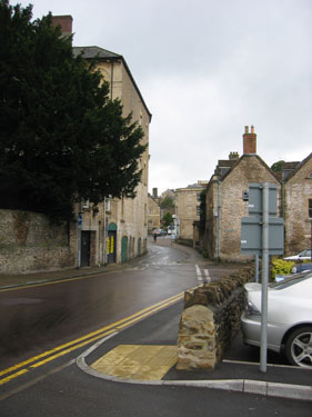 This road through Frome winds between close buildings on either side. 