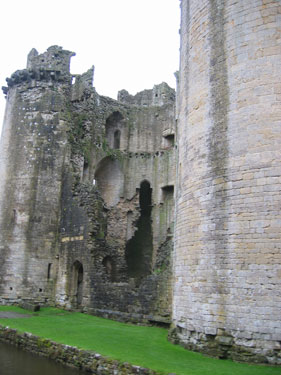 A picture showcasing the remains of Nunney Castle and its moat. 