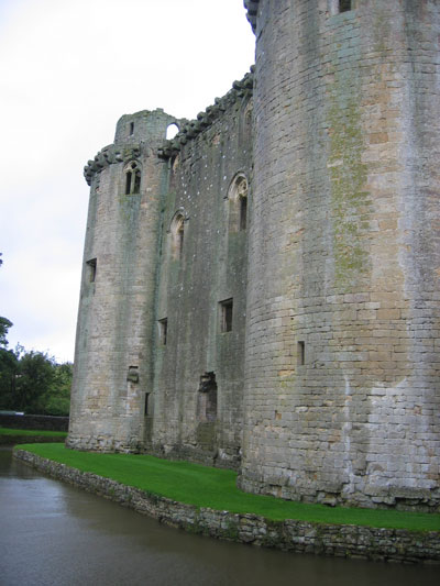 A picture showcasing the remains of Nunney Castle and its moat. 