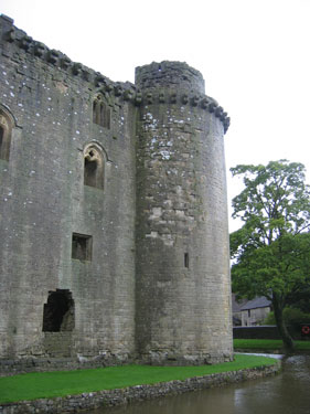 A picture showcasing the remains of Nunney Castle and its moat. 