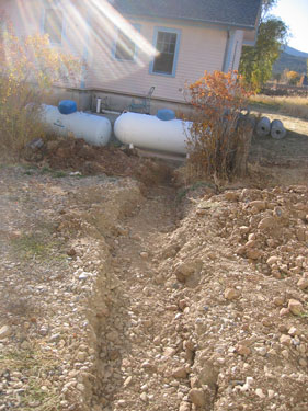 The trench for the new propane pipe has been filled in, though it still needs some smoothing over. 