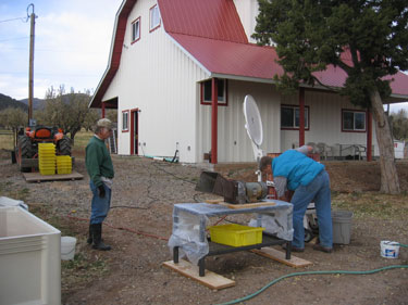 A station is set up to crush apples before putting them into the wine press.