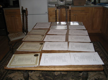 Paper pedigrees are laid out on a table for sorting. 