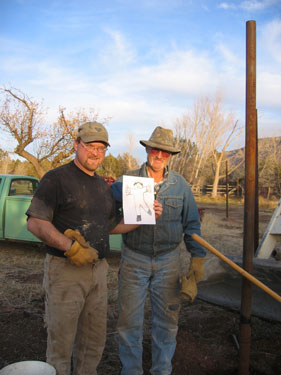 Larry and Andrew pose with Flat Stanley for the camera.