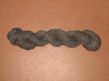 This is a grey skein of woolen yarn blend, ready for sale. 