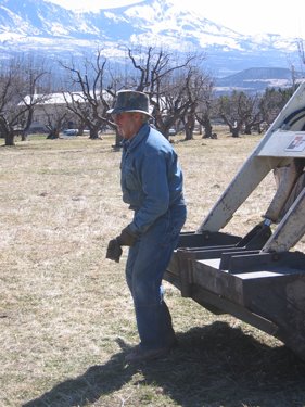 Larry is standing next to the tractor.