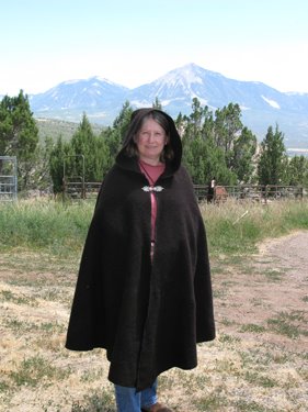 Oogie poses for the camera in her handmade Black Welsh Mountain wool cloak.