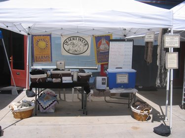 The Desert Weyr farmers' market booth, selling meat and wool.