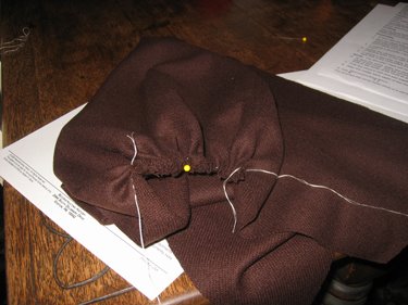 This picture shows the gathering of the cloak neckline and hood. 