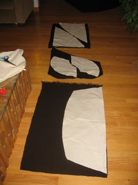 The pattern for the cloak, laid out on the wool pieces and ready to cut.