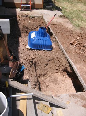 A blue plastic mold denotes the placement of a footer for the new porch.