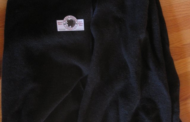 The Desert Weyr merchandise logo on black wool. 