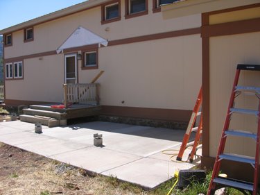 The new concrete porch currently isn't covered by a roof, but it will be soon. 