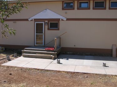The new concrete porch currently isn't covered by a roof, but it will be soon. 