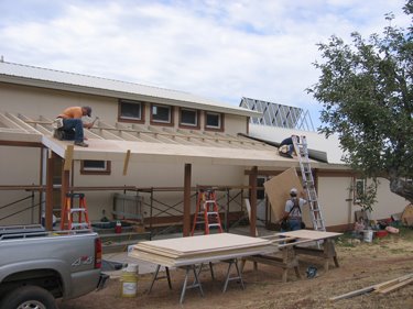 Plywood is finally being laid over the bracing. 