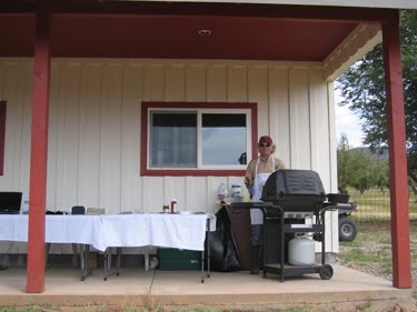 Ken mans the grill, preparing smoked kolbassi sausages for samples. 