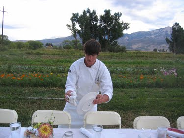 The student is cleaning rain off the plates.