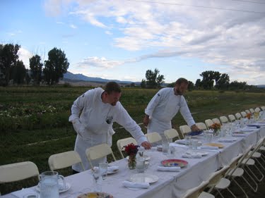 Several students work on setting the table.
