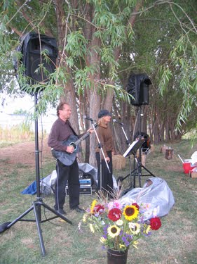 A live music act entertains the party-goers as the food is prepared.