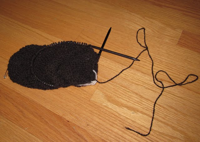 A knitting/frogging project made with black wool.