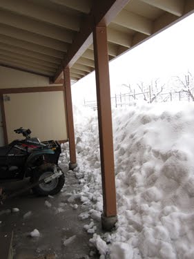 Snow has collected at the edge of the roof on this porch, meaning the quad beneath is just about snowed in.