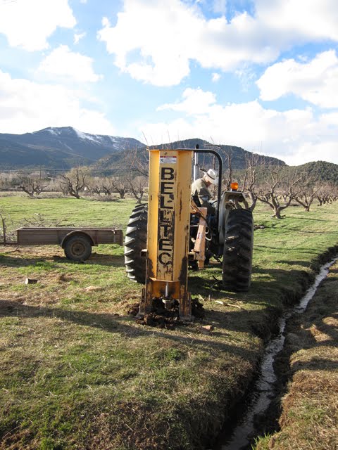 A post machine is placing poles for the new fence.