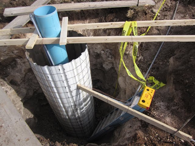 A close-up of a concrete form that will support the pole for a large solar panel array. 