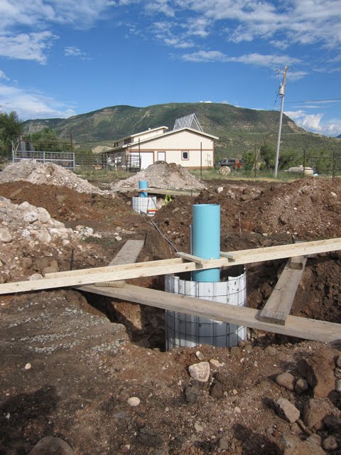 A concrete form for a large pole that will support a solar panel. 