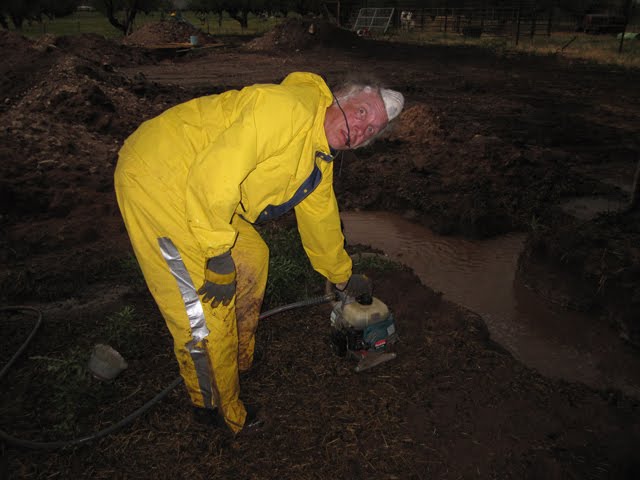 Ken with a pump, ready to pump out the collected water.
