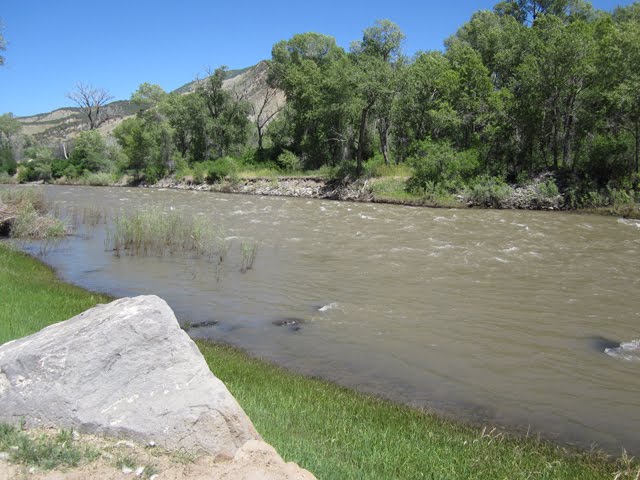 The river is brown and very high. 