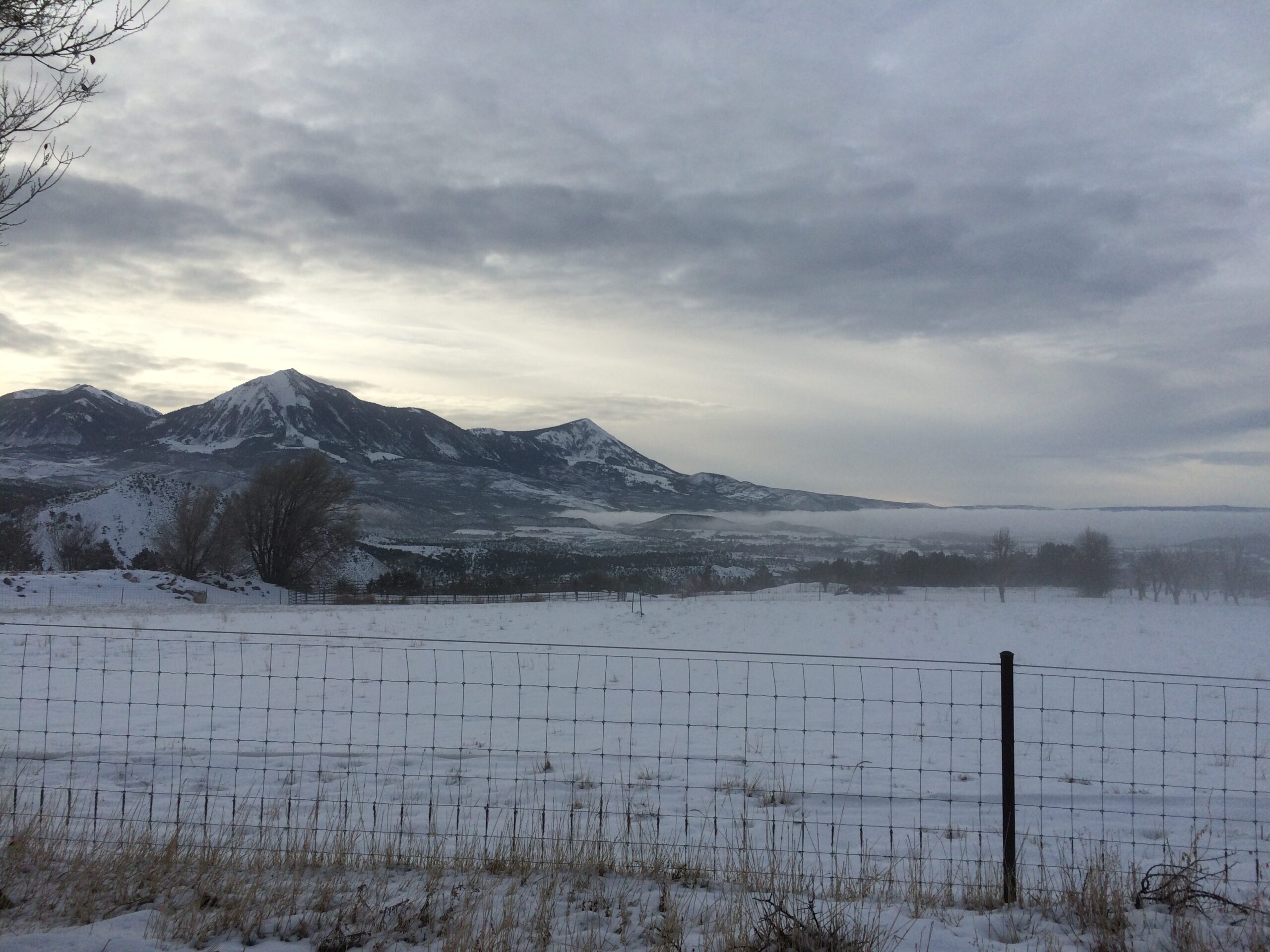A waning mist settles near the ground as the day begins.
