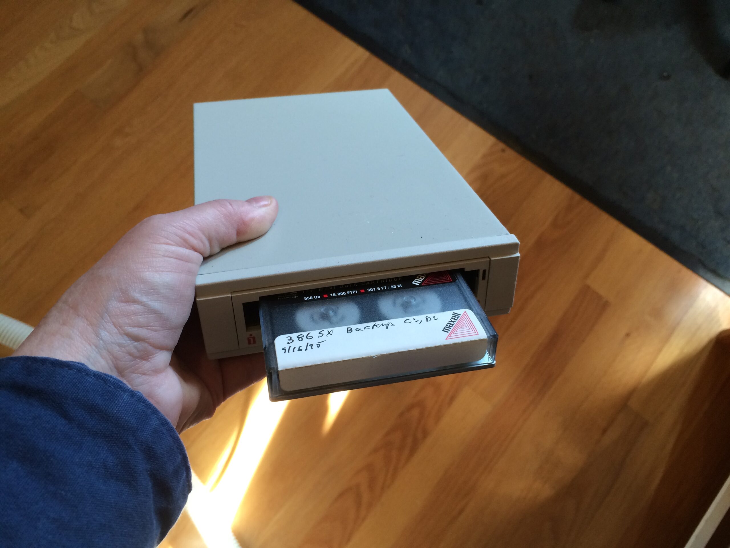 Oogie holds up an old tape drive for the camera.