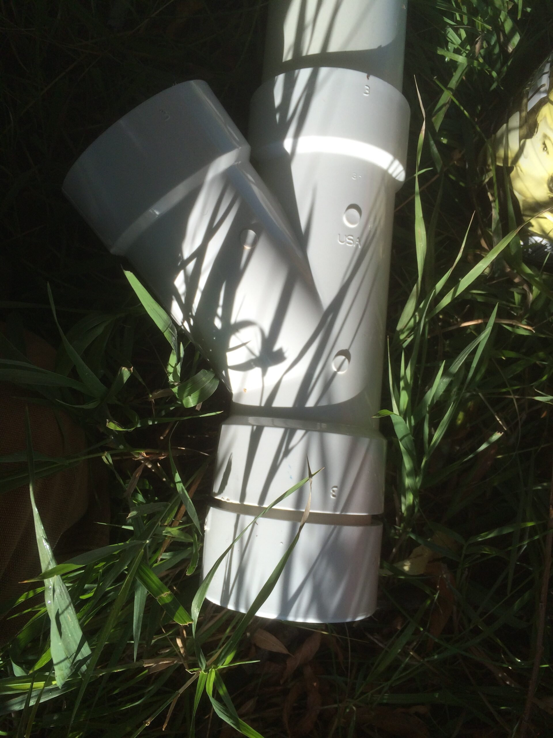 A close-up picture of the Y-bend in the PVC chicken feeder. 