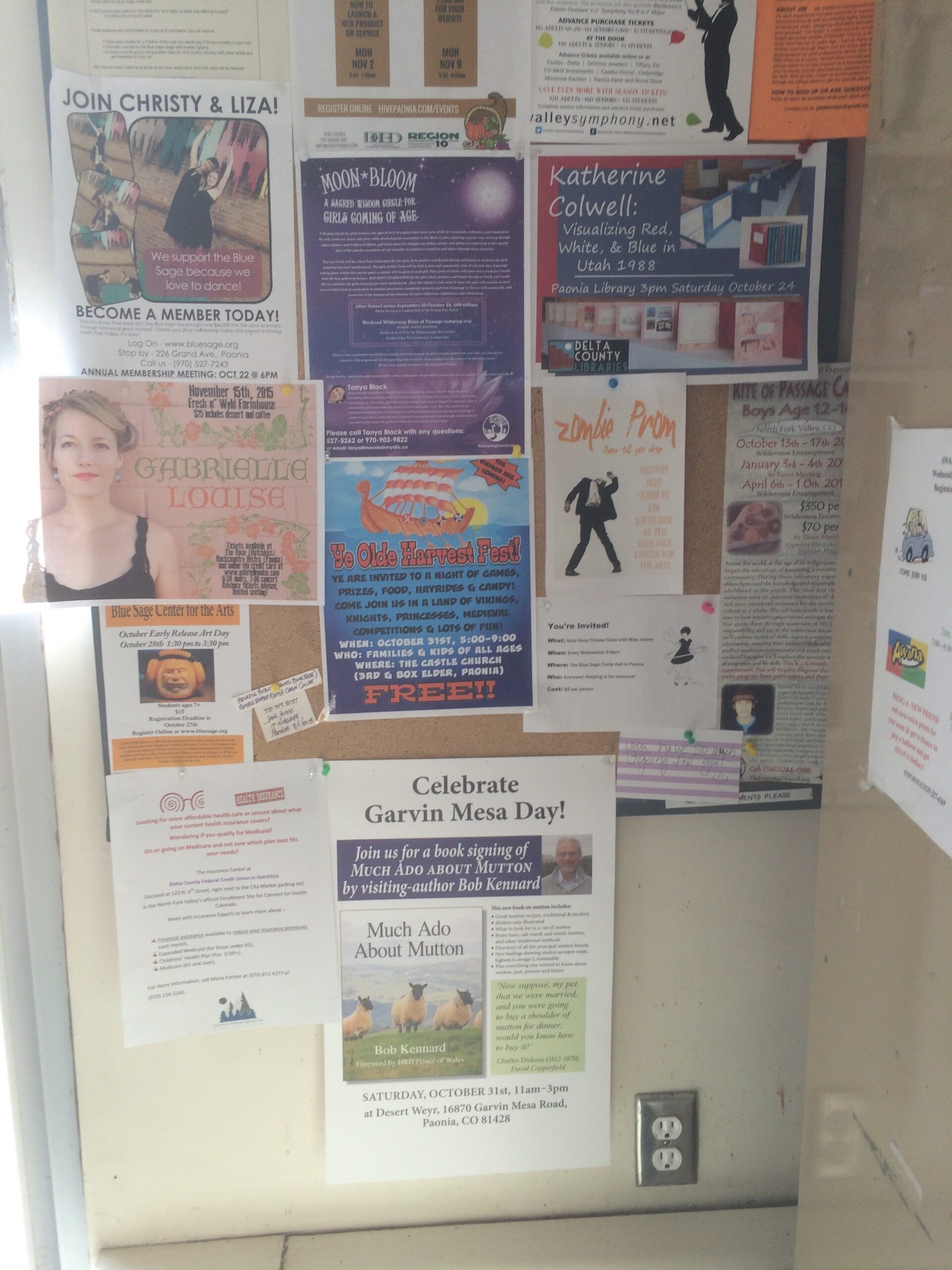 Various posters hang on a bulletin board, including one advertising Garvin Mesa Day.