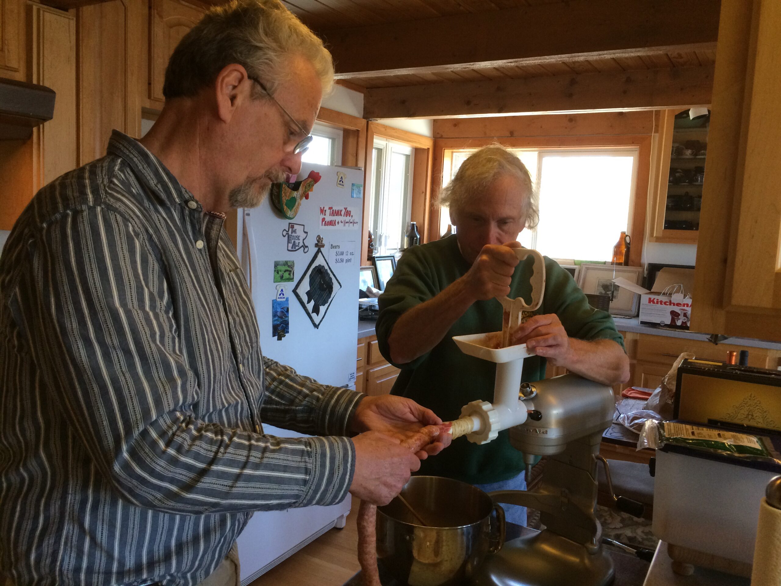 Bob and Ken stiff the sausage into casings.