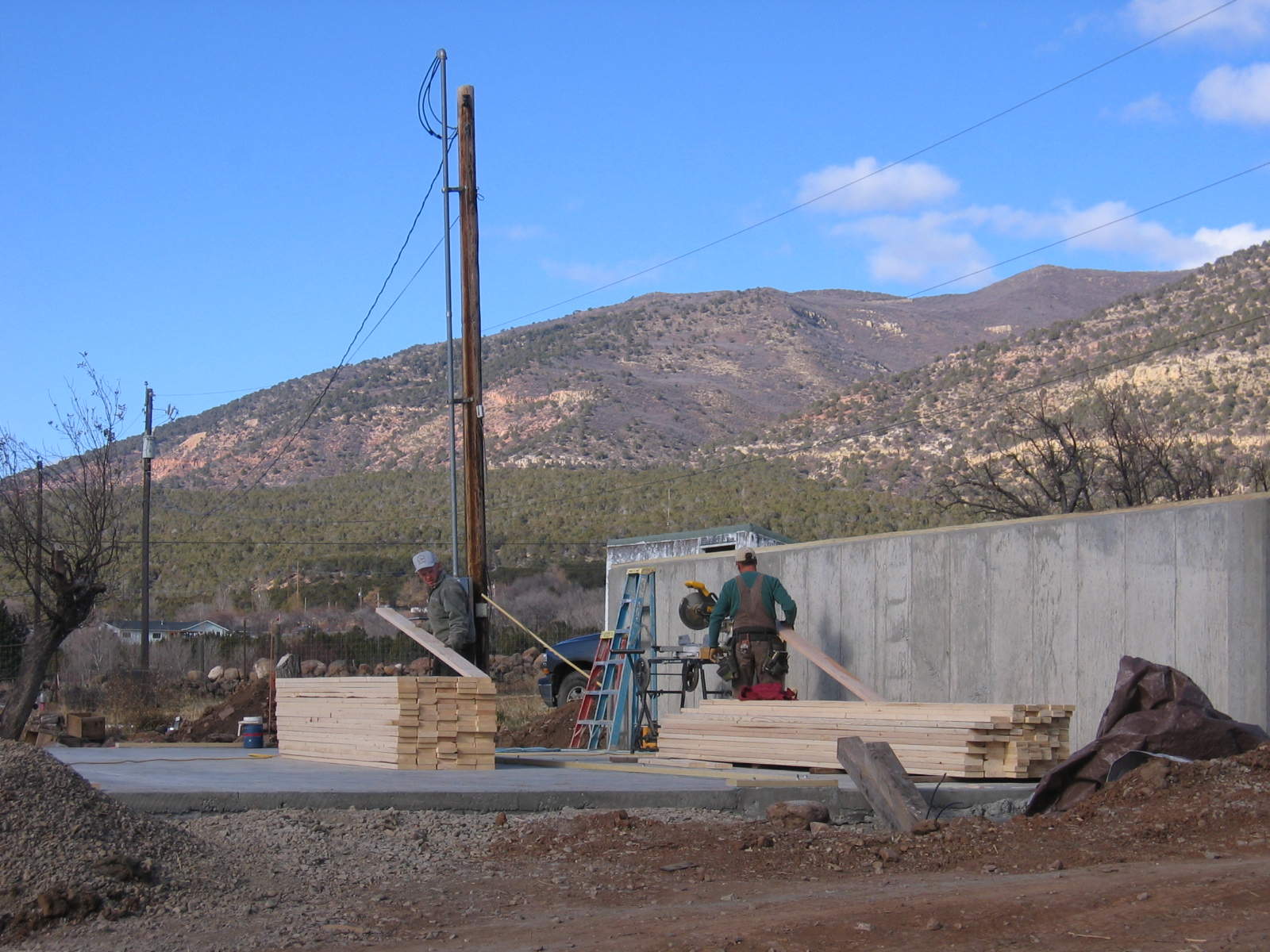 Lumber has been brought in, and the walls of the new shop are being built. 