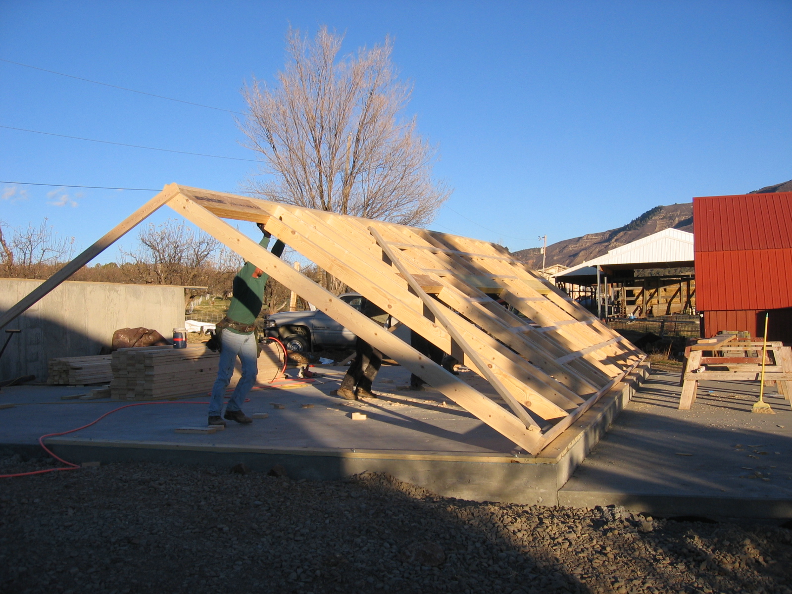 The first wall of the new shop is being raised. 