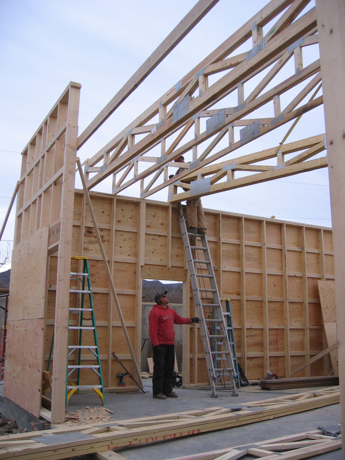 Plywood sheeting is being put up on the new shop. 