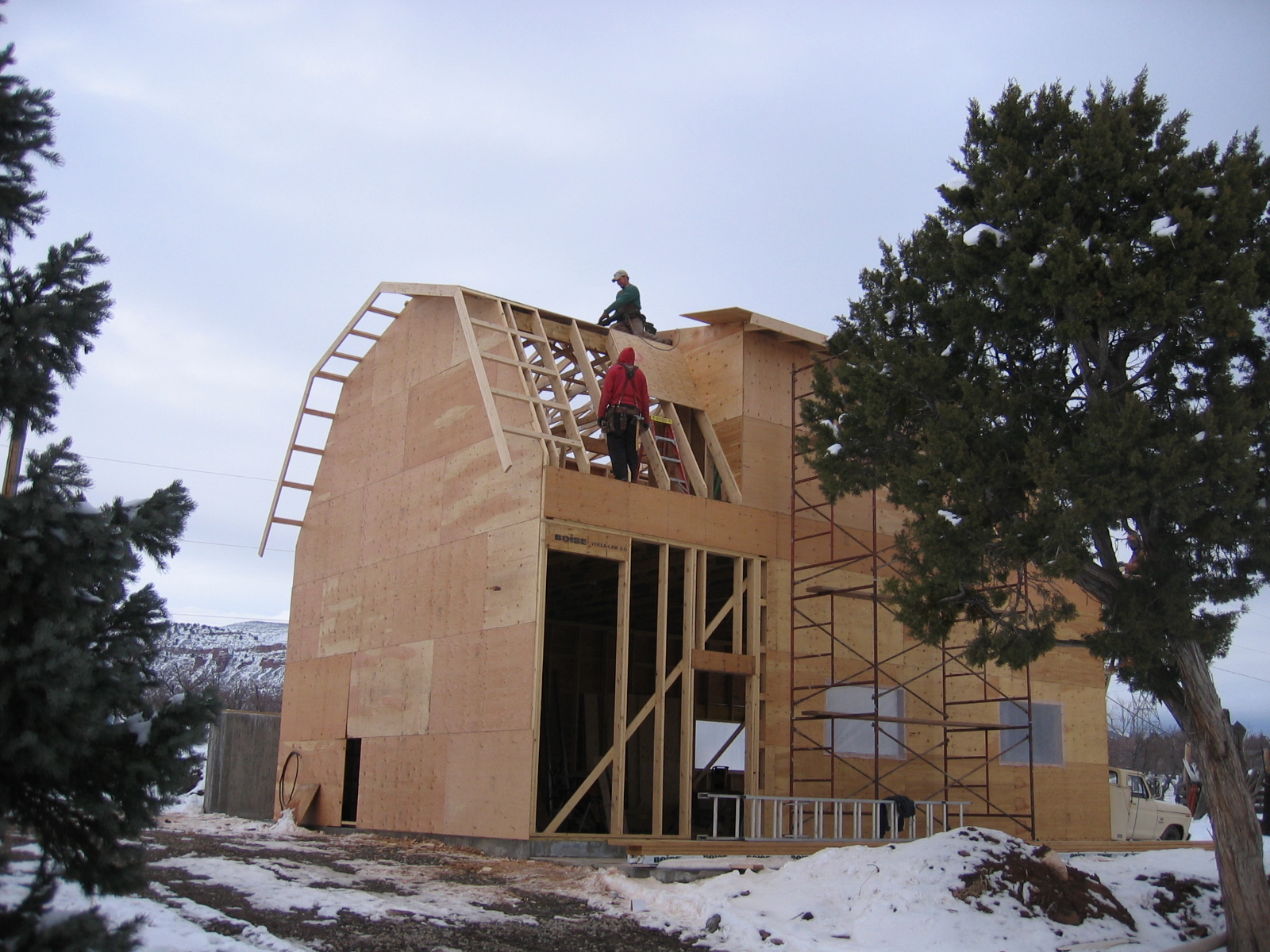 Work continues on the new shop, with plywood sheathing going on. 
